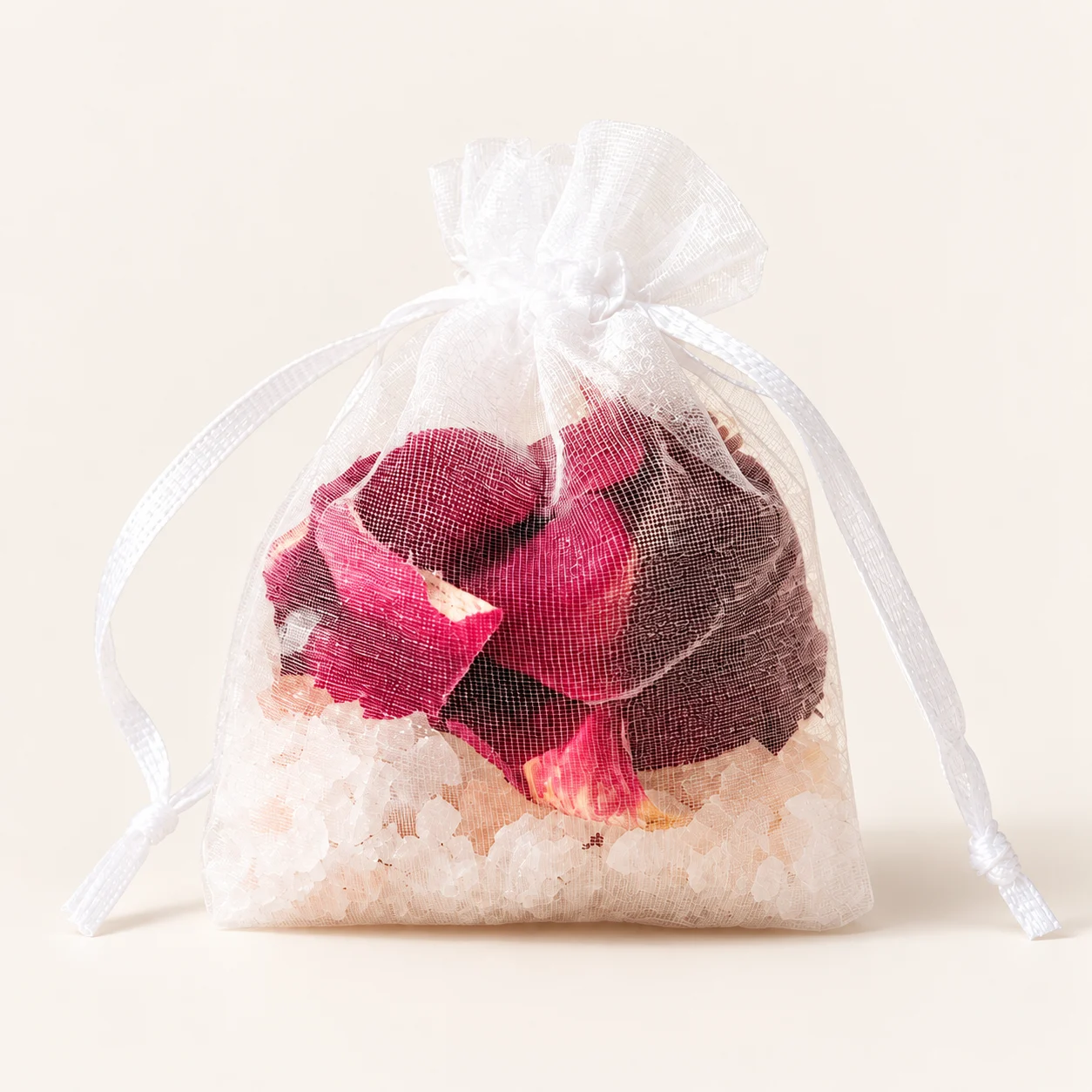 Rose petals and bath salts in a white organza sachet