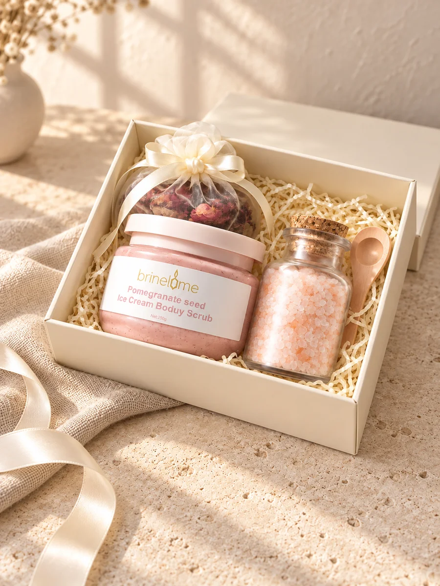 An open cream gift box with body scrub, botanical bath salts and a satin bow.